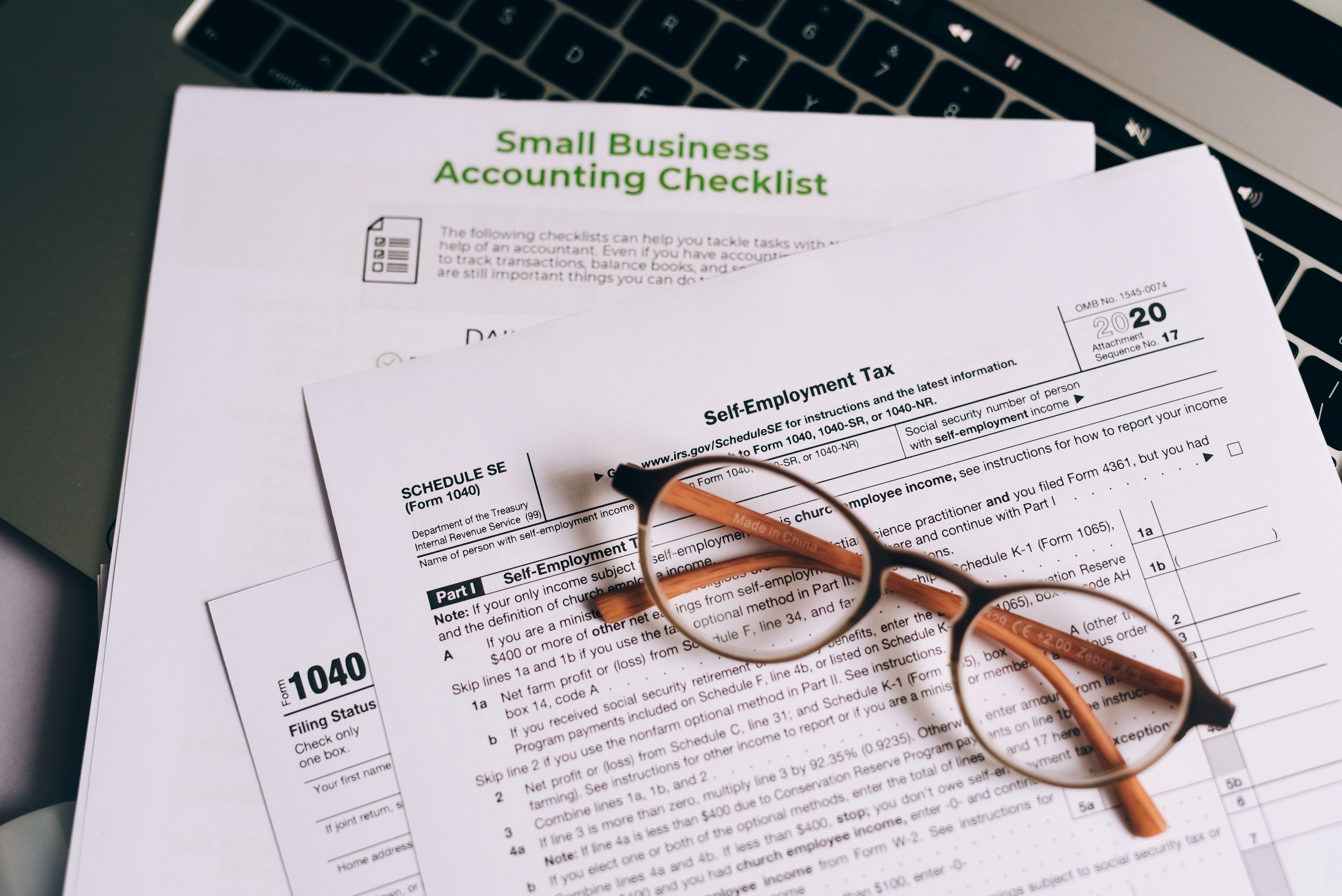 Small business accounting checklist with glasses resting on top