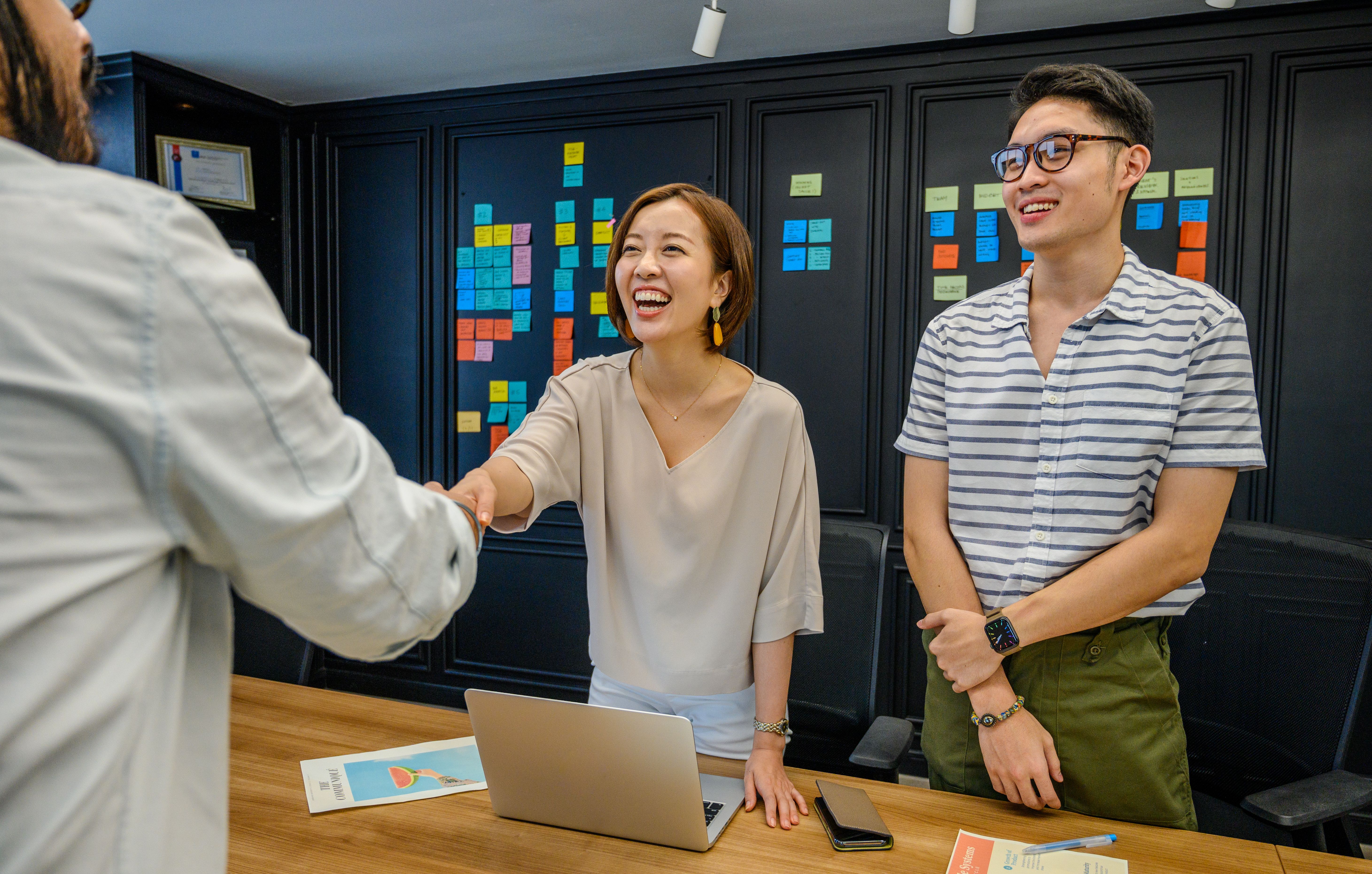 A professional team shaking hands in an office setting